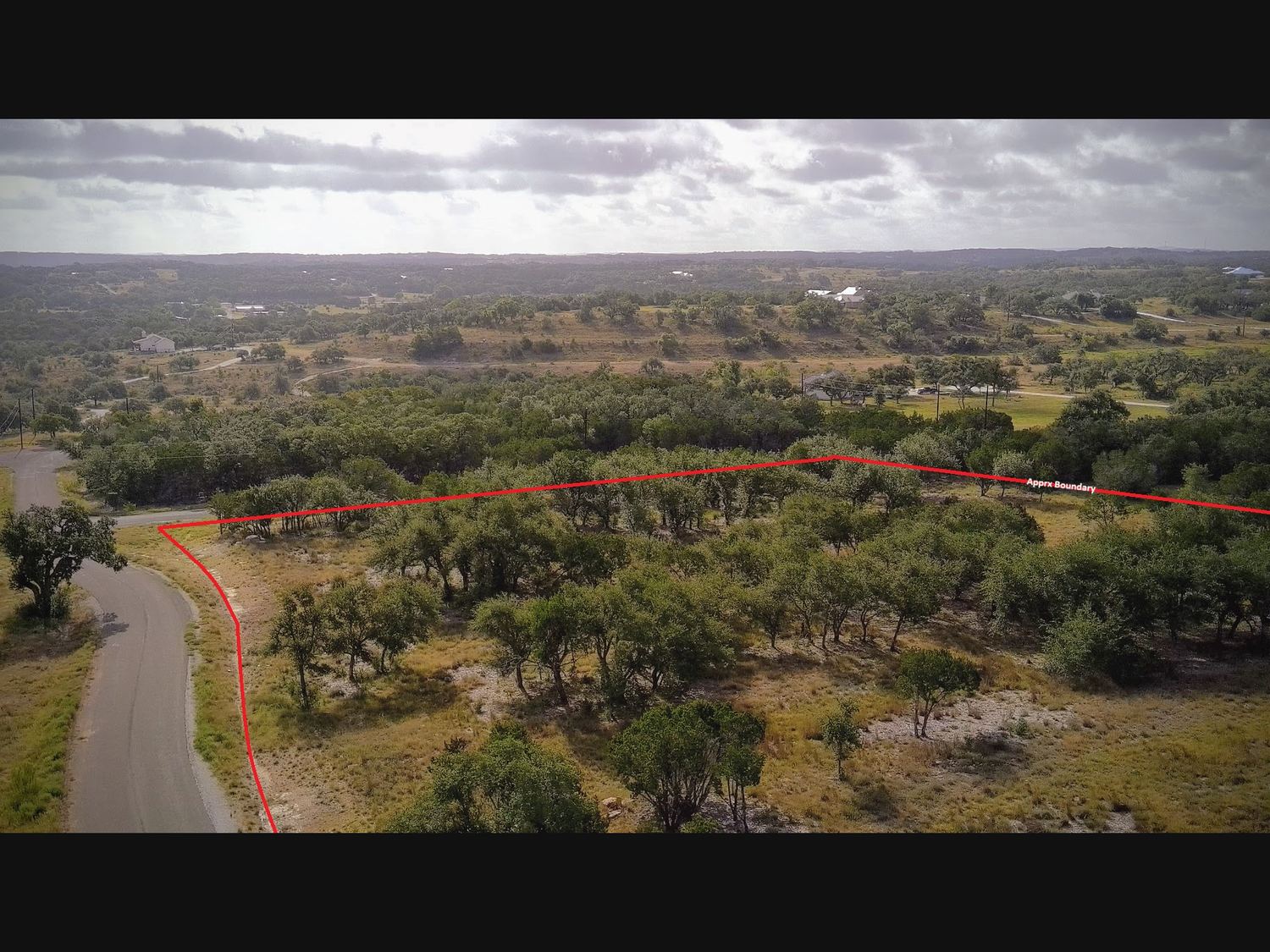 Aerial view of Lot 73 with approximate boundary marked, showing road frontage on two sides