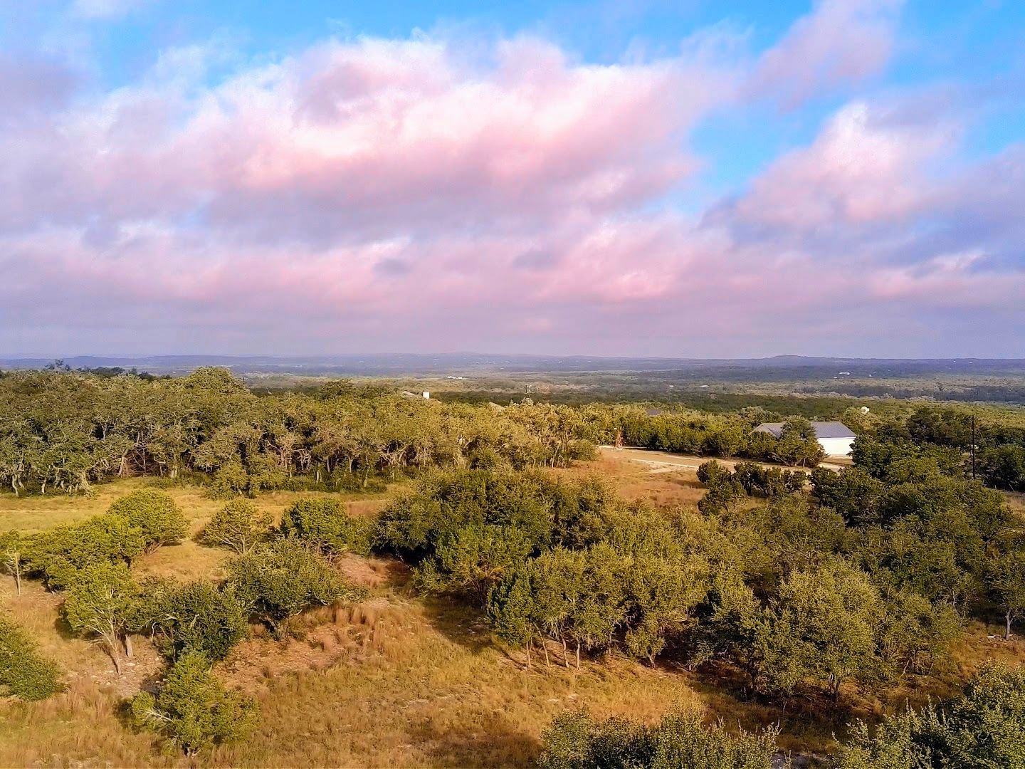 Evening light over Lot 73 with oak cover rolling out to the Hill Country horizon